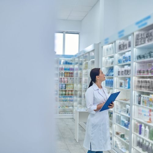 Pharmacist checking medicines in a drugstore Drugstore. Pharmacist checking medicines in a drugstore